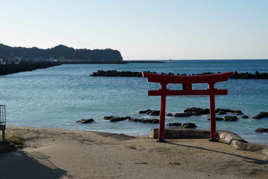 勝浦中央海水浴場と熊野神社の鳥居。濃く青い空と、薄青い海と、赤い鳥居の組み合わせが美しい