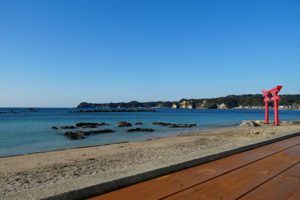 勝浦中央海水浴場と鵜原方面の岬の写真。外房でも独特の長い砂浜とその先の岩場が美しい